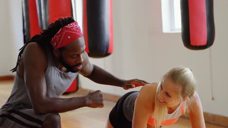 trainer training female boxer in fitness studio 4k