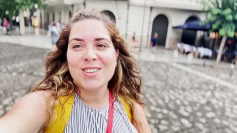 vlogger woman looking up and gesturing during athens tour