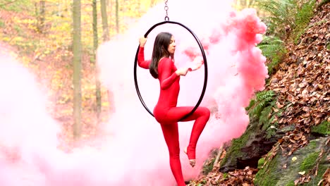 young woman doing aerial hoop dance outdoors