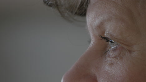 senior woman staring into distance, extreme close up face view