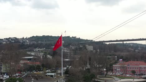 turkish flag next to the bridge in istanbul bosphorus