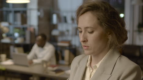 portrait of a businesswoman talking on mobile phone while standing in the office