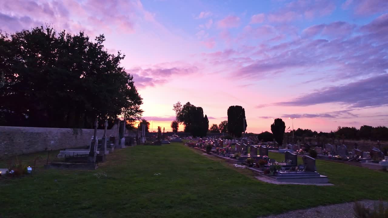 Amazing sunset somewhere in an ordinary cemetery in countryside at France