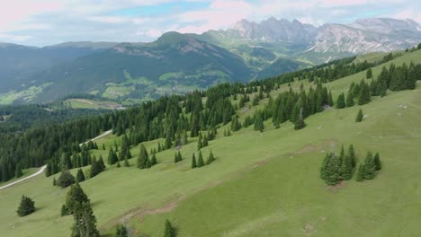 A-slow-tilt-up-aerial-footage-capturing-lush-green-slopes-near-Santa-Cristina,-South-Tyrol,-Dolomites,-Italy