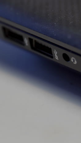 hand connecting a usb cable to a laptop