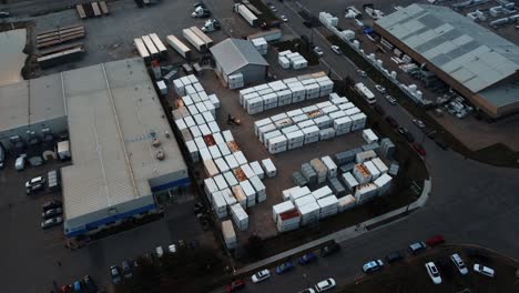A lot of shipping containers by warehouse from a drone perspective