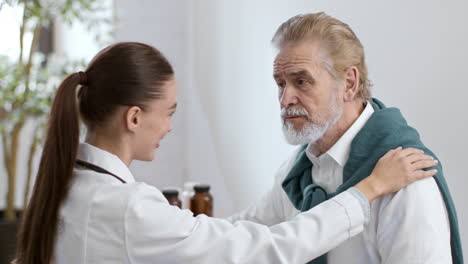 doctor comforting elderly patient