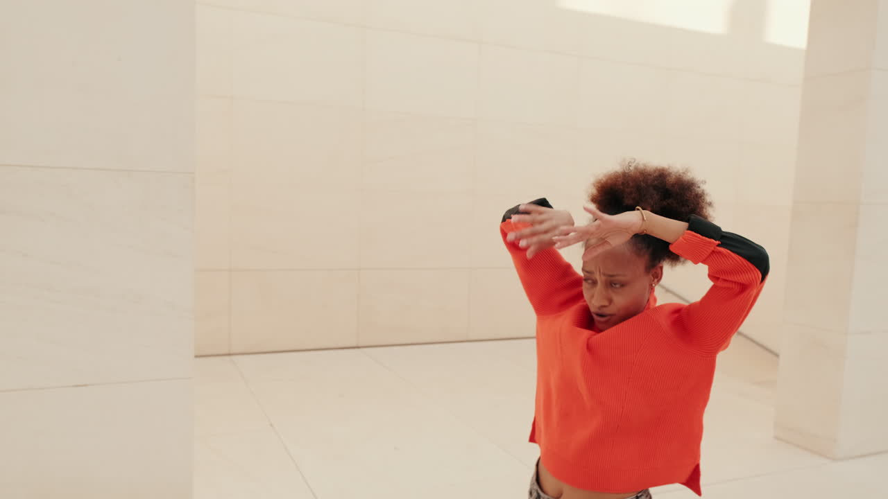 Young Woman Dances Freely in Modern Setting