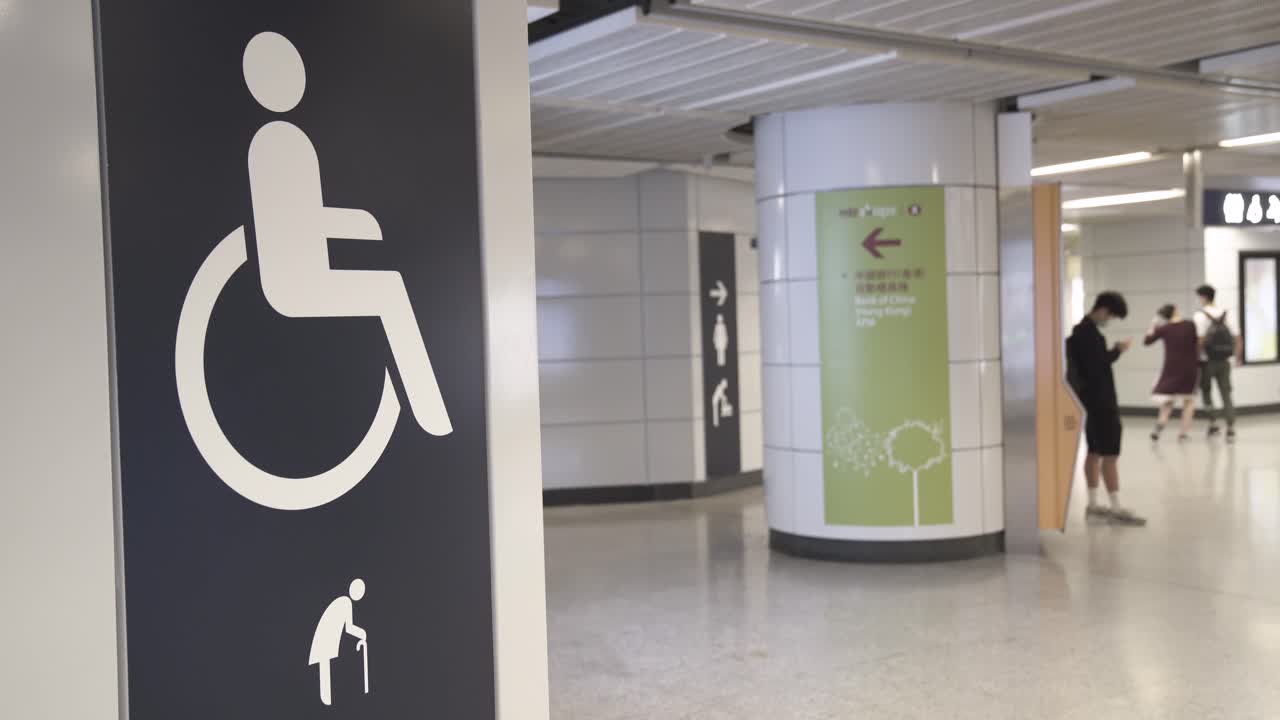 A sign indicates the entrance and the toilet for wheelchair and elderly users in a subway station in Central district, Hong Kong.