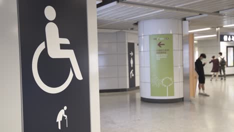a sign indicates the entrance and the toilet for wheelchair and elderly users in a subway station in central district, hong kong.