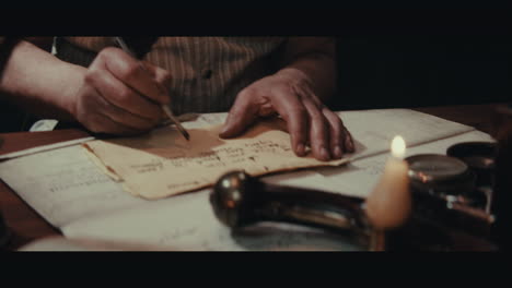 An old captain sits writes a letter inside the sailing ship cabin