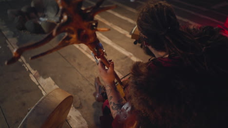 yakut man in national costume plays string instrument