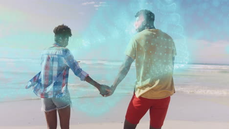 couple holding hands on beach with sparkling blue animation overlay