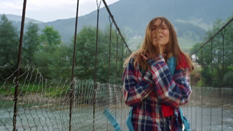 backpacker dancing nature outdoors. happy woman gesture hands on holiday travel.