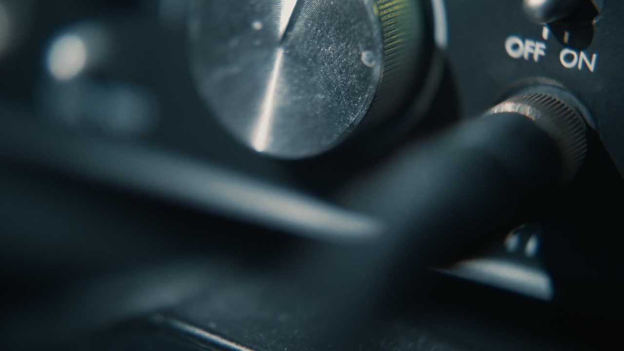 Close Up of Hand Plugging Audio Jack into Headphone Port