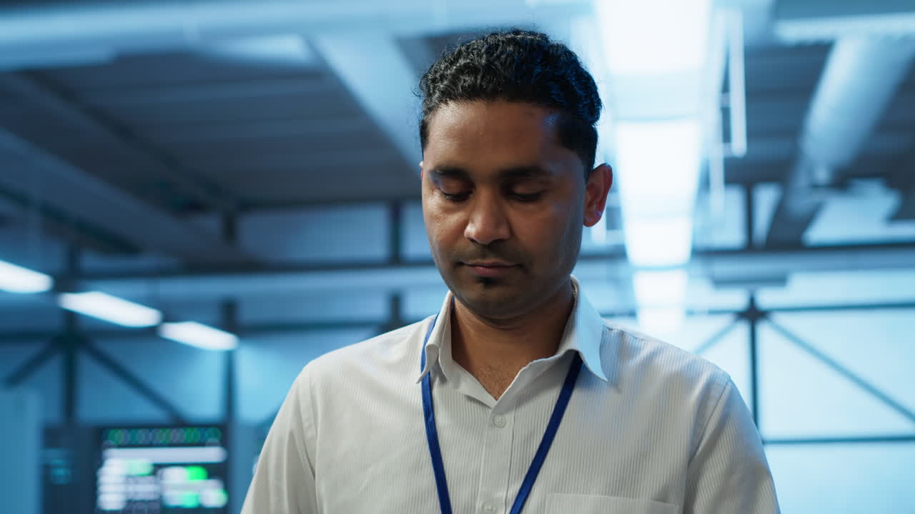 administrador del sistema caminando en el centro de datos utilizado para administrar la energía del engranaje