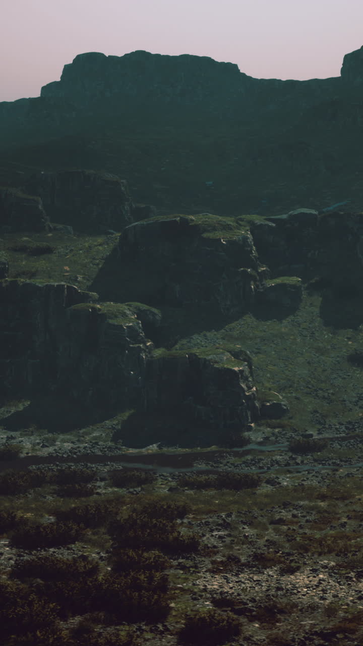 Mysterious mountain landscape captured in twilight hues near rocky formations