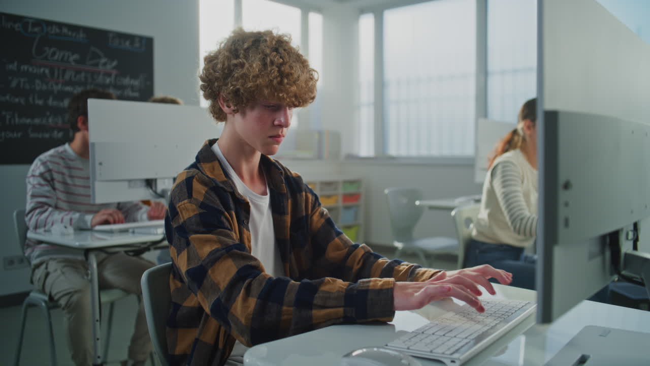 Student in Checkered Shirt Doing Examination Project on Game Development