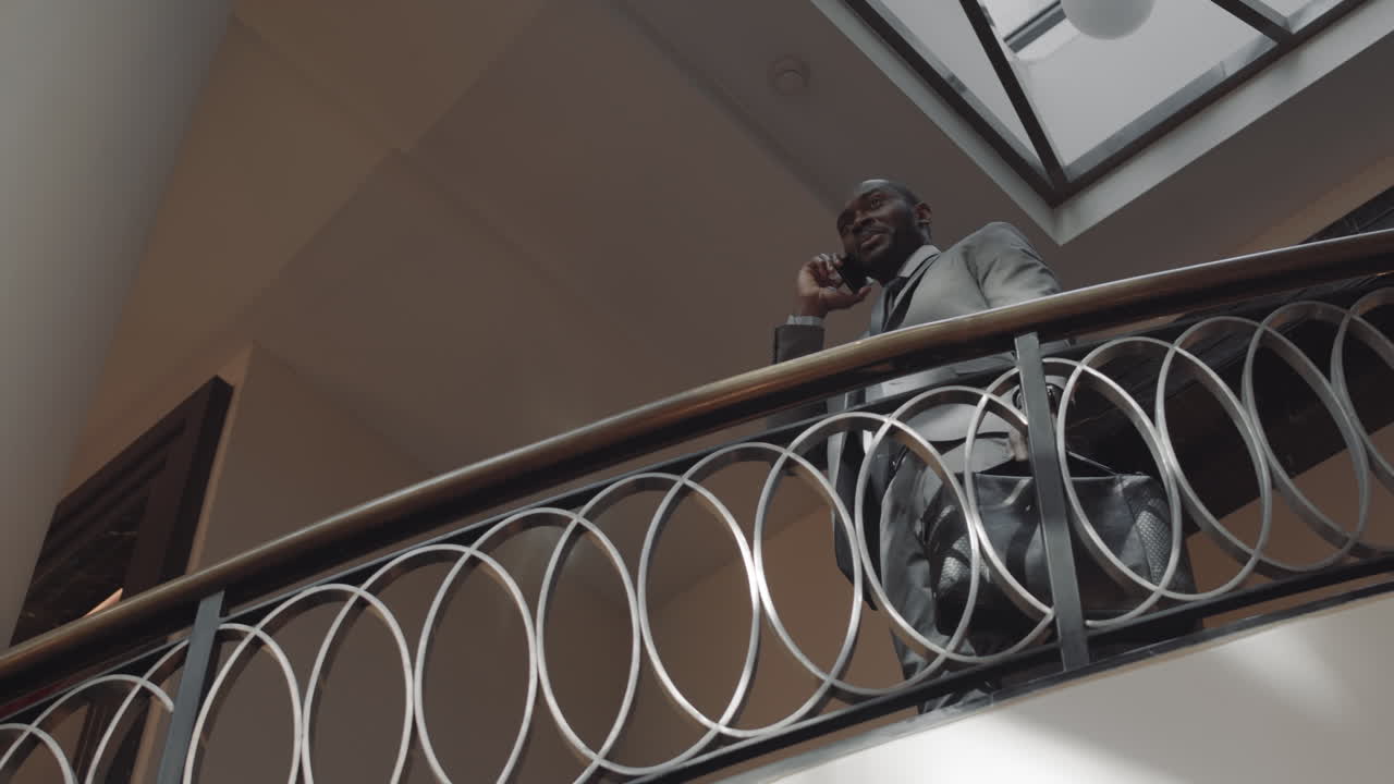 CEO with Cellphone on Staircase