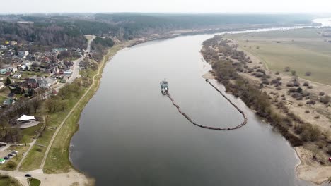 Industrial-barge-dredging-river-in-aerial-high-angle-drone-view