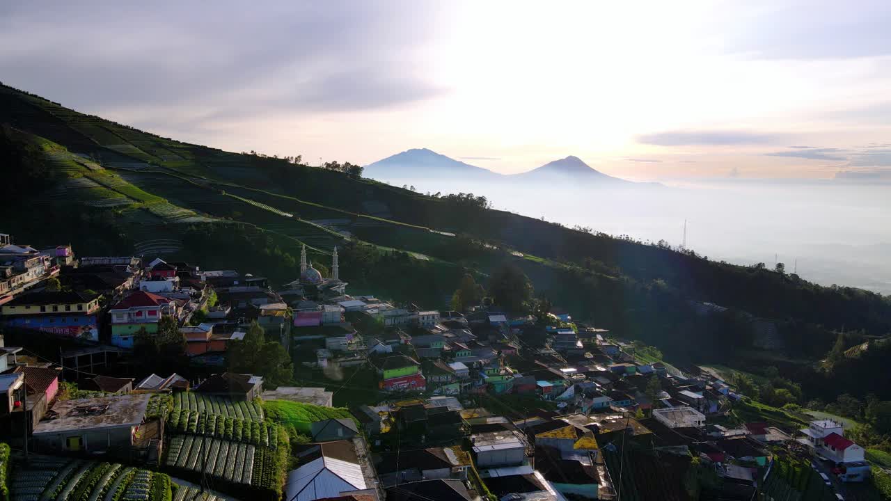 Aerial view of Butuh Nepal Van Java village in the slope of a volcano with a misty landscape in background