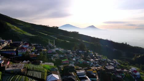 Aerial-view-of-Butuh-Nepal-Van-Java-village-in-the-slope-of-a-volcano-with-a-misty-landscape-in-background