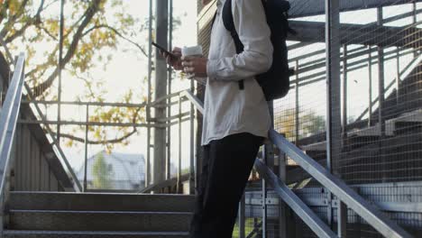 young man using smartphone on stairs