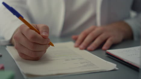 doctor hands writing medical documents close up. unknown medic filling journal.