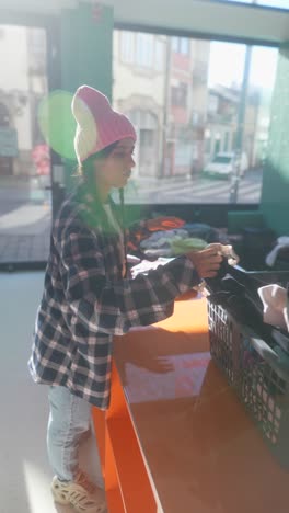 young woman volunteering at a clothing donation center