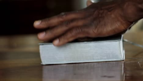 man-praying-to-God-with-hand-on-bible-with-people-stock-video-stock-footage