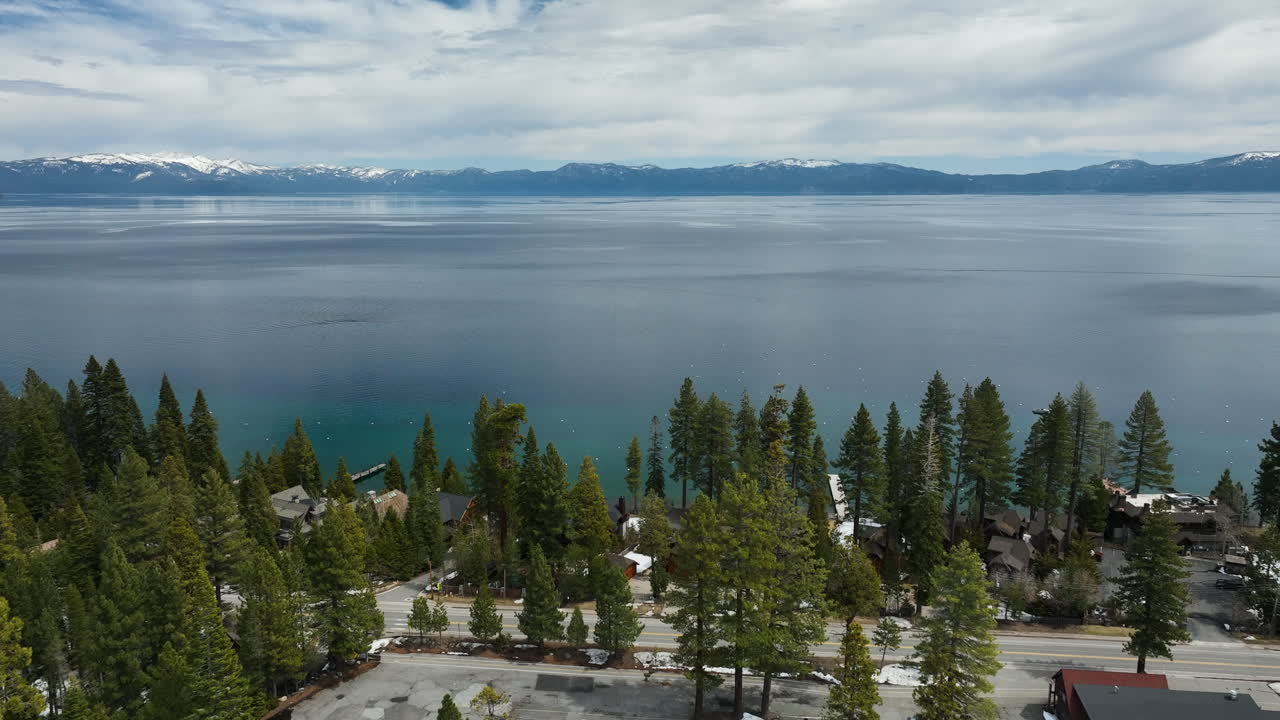 Aerial view over the coast of Lake Tahoe, cloudy, spring day in California, USA