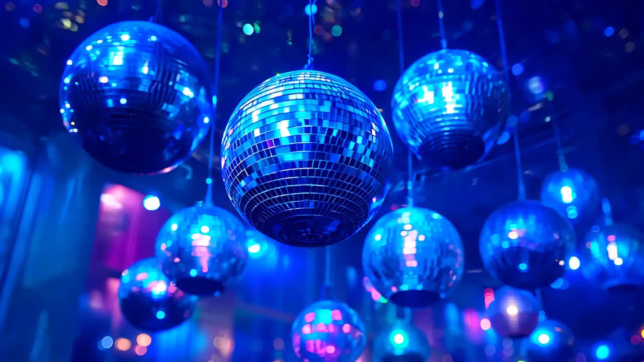 A room with many colorful disco balls hanging from the ceiling. Scene is lively and fun, as the bright colors and the disco balls suggest a party or a dance event