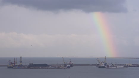 rainbow on a cloudy day in the port of melilla