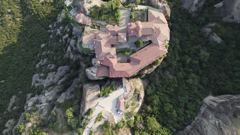 drone top down view of clifftop saint stephen nunnery , meteora