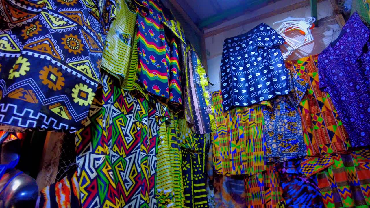 POV shot looking at traditonal clothing at a market stalls in Serekunda, Gambia