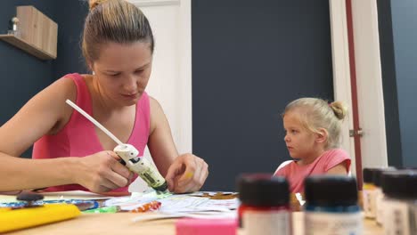 mother and daughter doing a craft project together