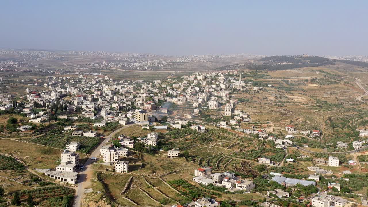 Aerial View of a Hilly Village Landscape with Buildings and Terraced Fields