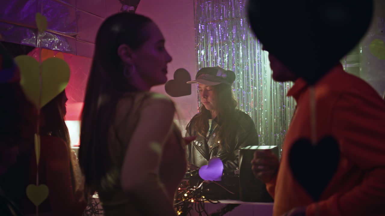 People dancing dj music enjoying rhythmic beats in nightclub. Disc jockey mixing