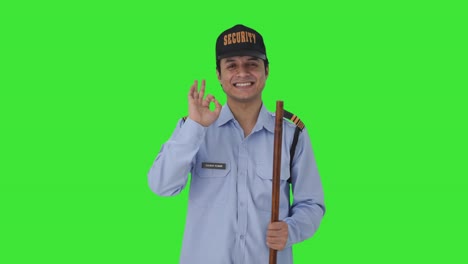 Happy-Indian-security-guard-showing-okay-sign-Green-screen