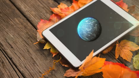 animation of tablet with globe over leaves