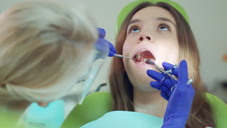 Dentista-Haciendo-Inyección-De-Anestésico-En-El-Diente-Del-Paciente