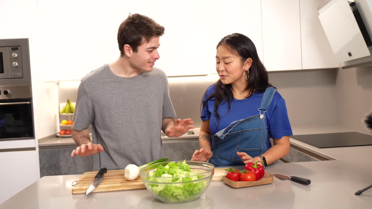 People preparing a salad in the kitchen