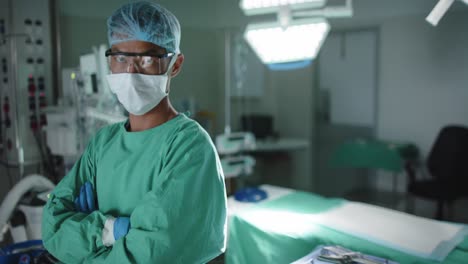 Portrait-of-serious-asian-male-surgeon-with-arms-crossed-in-operating-room-in-slow-motion