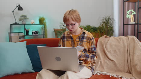 stressed young woman looking at unpaid bank debt loan doing paperwork planning budget throws bills
