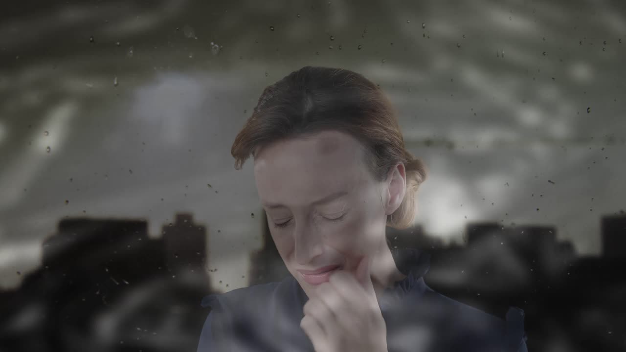 Animation of cityscape over sad caucasian woman touching her cheek