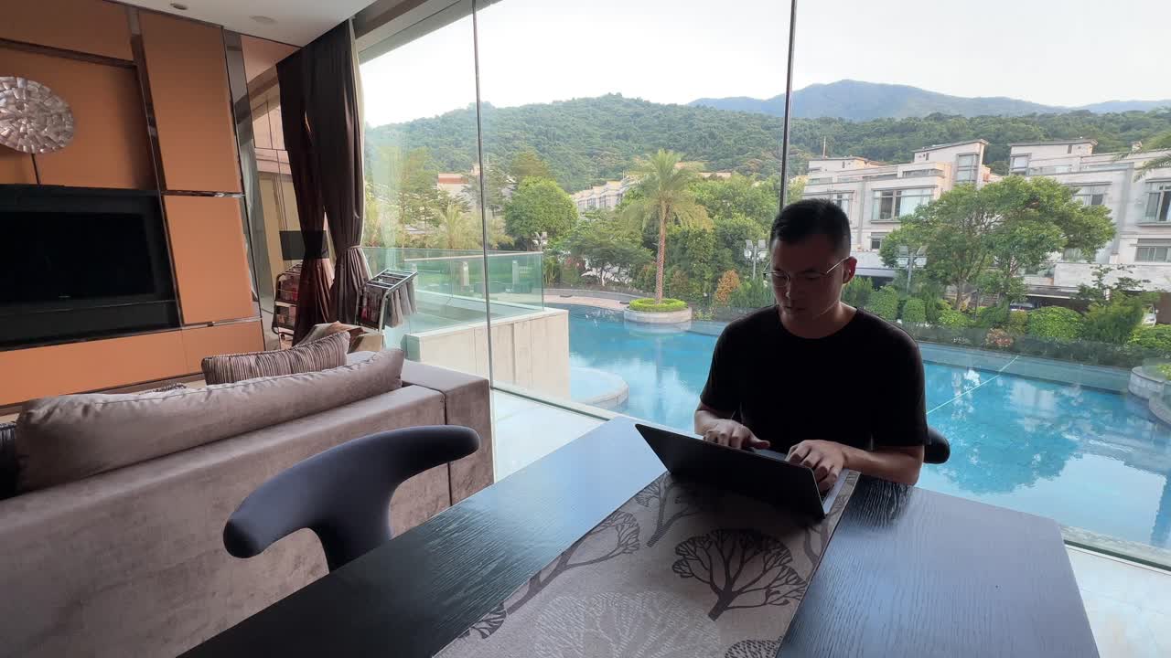 Wealthy Asian Millennial Entrepreneur Man Typing on Laptop In Luxurious Living Room