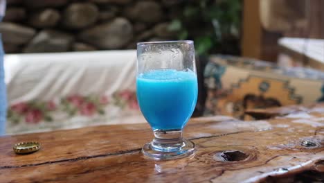 refreshing blue beverage in a rustic setting