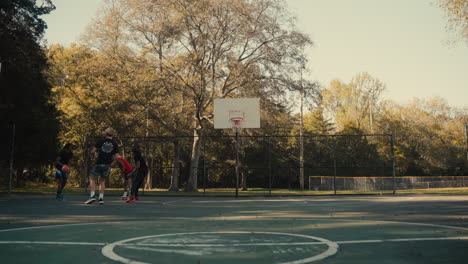 friends playing basketball outdoors