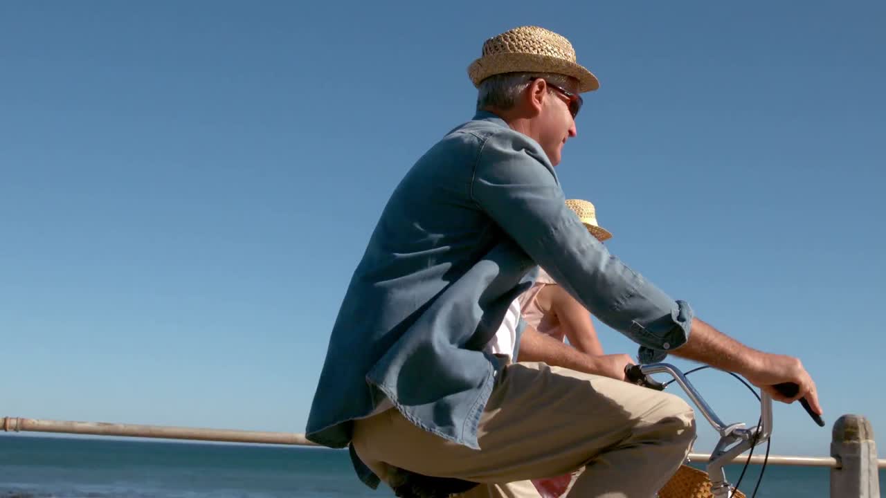 Senior couple going on a bike ride on the pier
