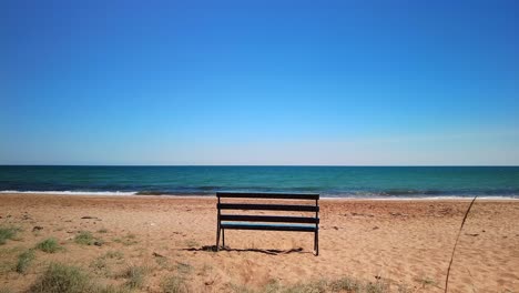 Empty-bench-on-the-beach-in-beautiful-sunny-weather